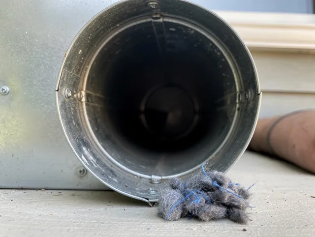 Whitman Dryer Vent Cleaning technician using specialized equipment to clear severe dryer vent blockage in Whitman